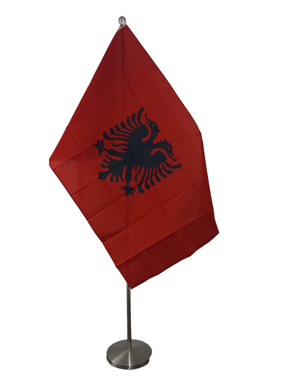Flag of Albania with a red background and a black double-headed eagle in the center, featuring two metal grommets for flying. On a ceremonial Pole.