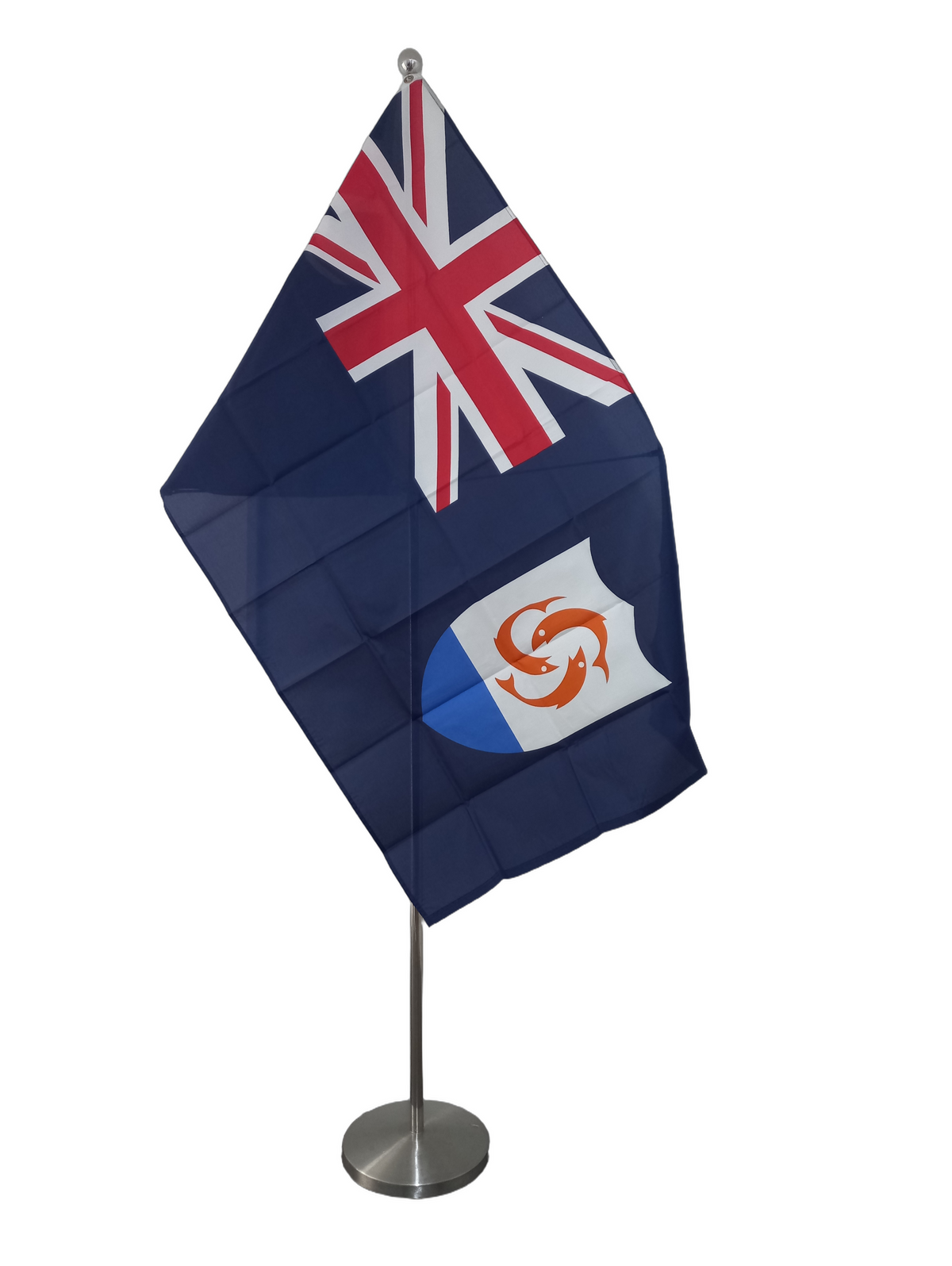 Flag of Anguilla featuring the Union Jack and a shield emblem on a blue background with two metal grommets for flying. On a ceremonial flagpole.