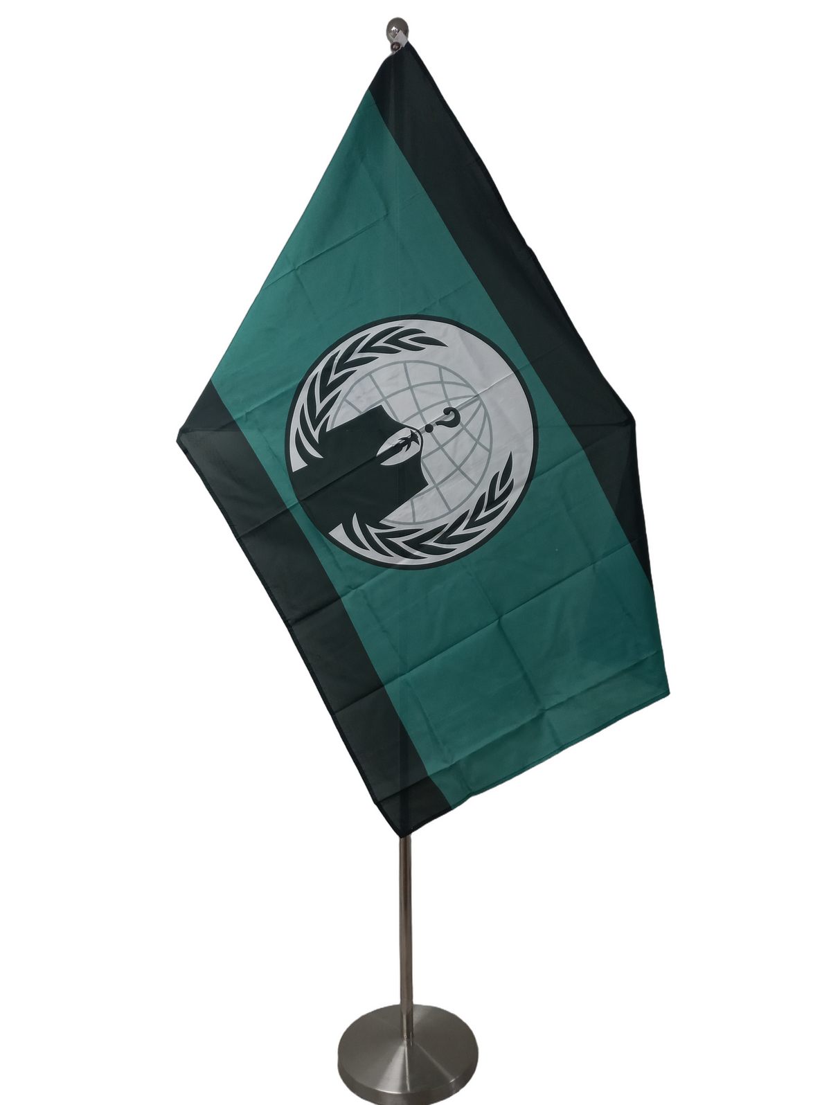A flag with a green and black color scheme featuring a central emblem with a question mark and laurel wreath, flanked by solid green vertical bands, with two metal grommets for flying. On a ceremonial flagpole.