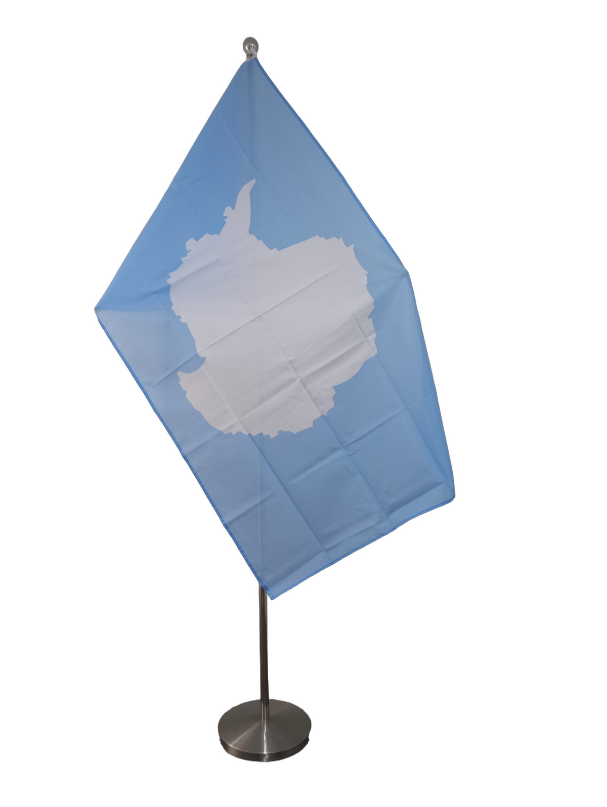 Flag of Antarctica with a white silhouette of the continent on a blue background with two metal grommets for flying. On a ceremonial flagpole.