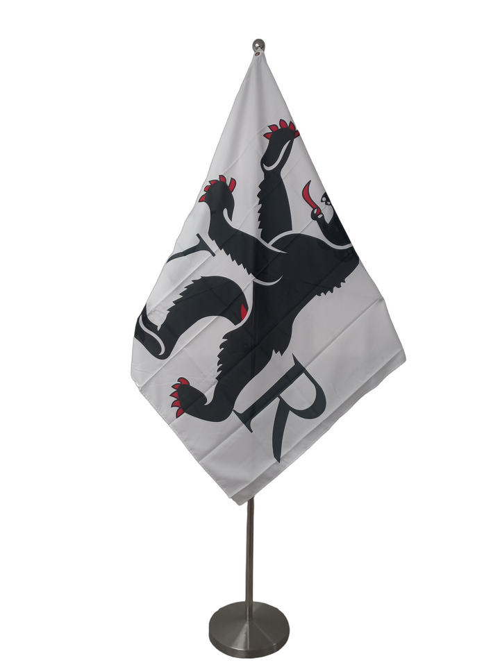 White flag with the a bear and the letters V and R on either side. On a ceremonial flagpole.