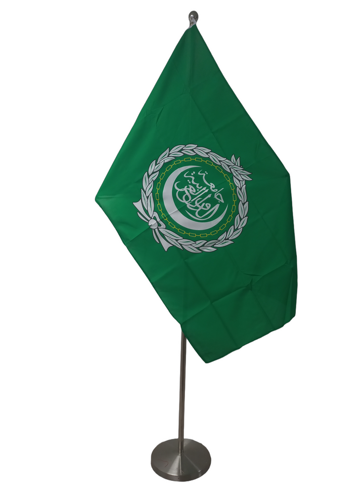 Flag of the League of Arab Nations with a green background and white emblem featuring text and a olive branch. On a ceremonial flagpole.