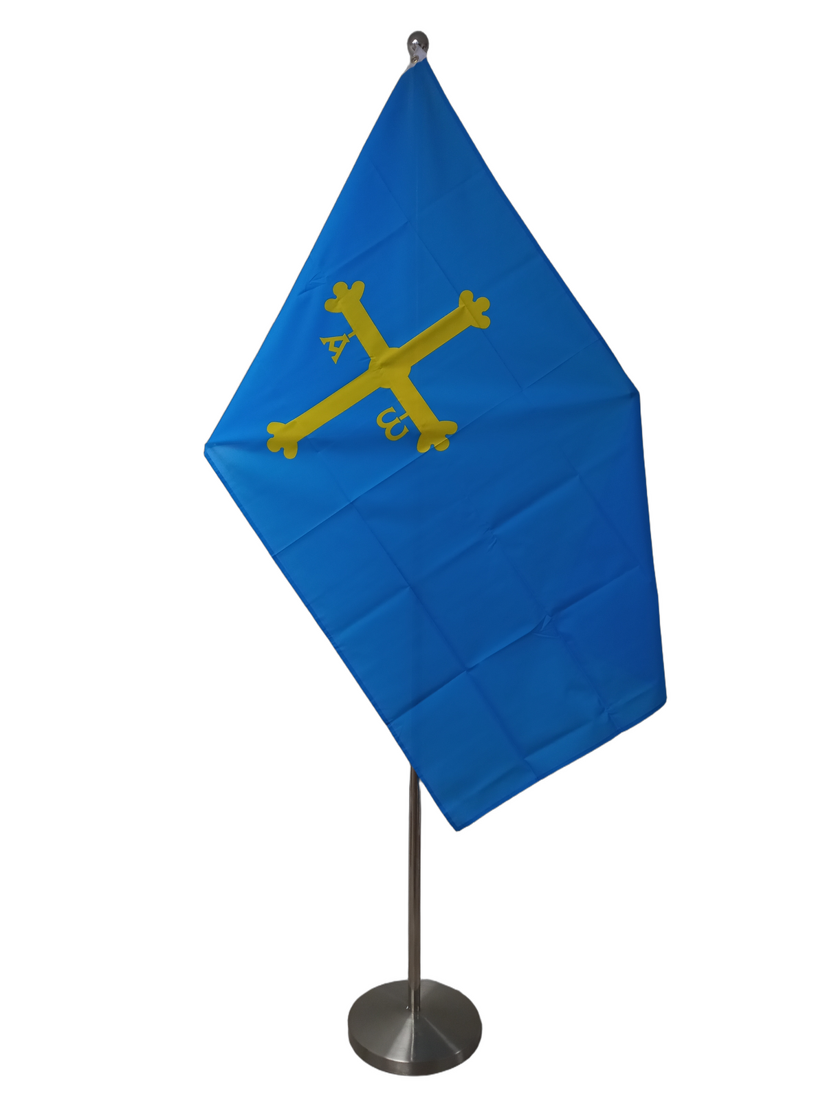 Flag of Asturias, Spain with a solid blue background and a yellow cross in the center, displayed with two metal grommets for flying. On a ceremonial flagpole.