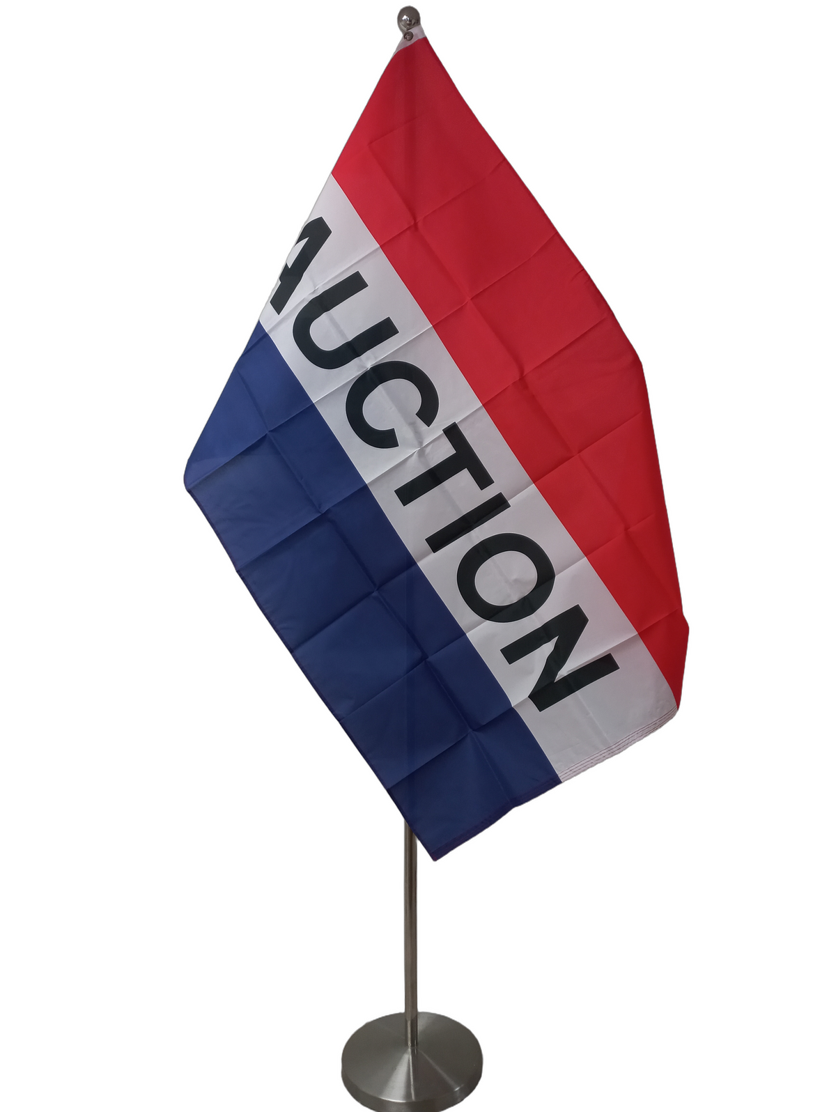 A flag with three horizonal stripes; red, white and blue with black text Auction in the middle. On a ceremonial flagpole.