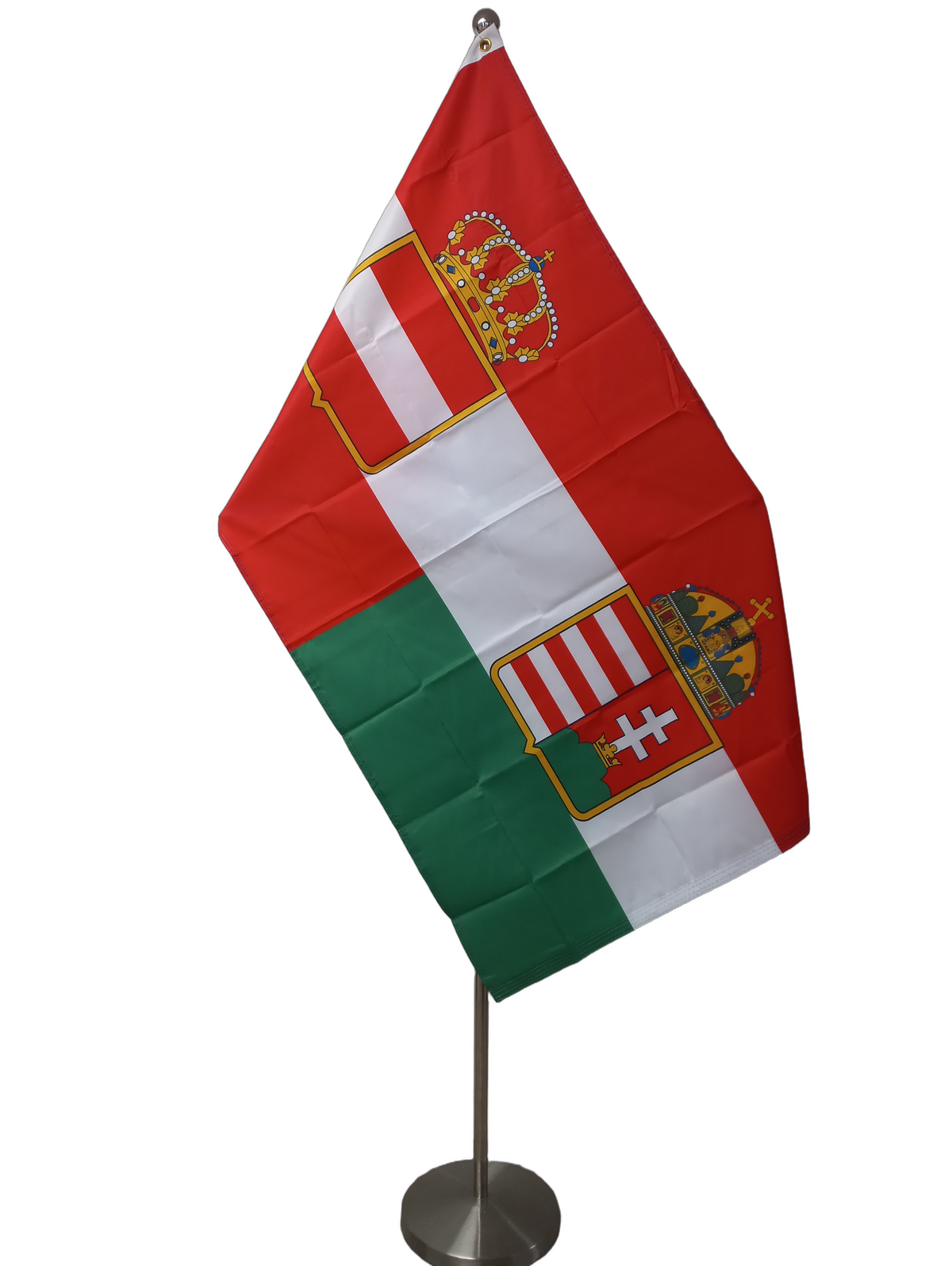 A flag with two coats of arms, one red with a white rectangle and gold crown, and one green with a white cross and red emblem, with two metal grommets for flying. On a ceremonial flag pole.