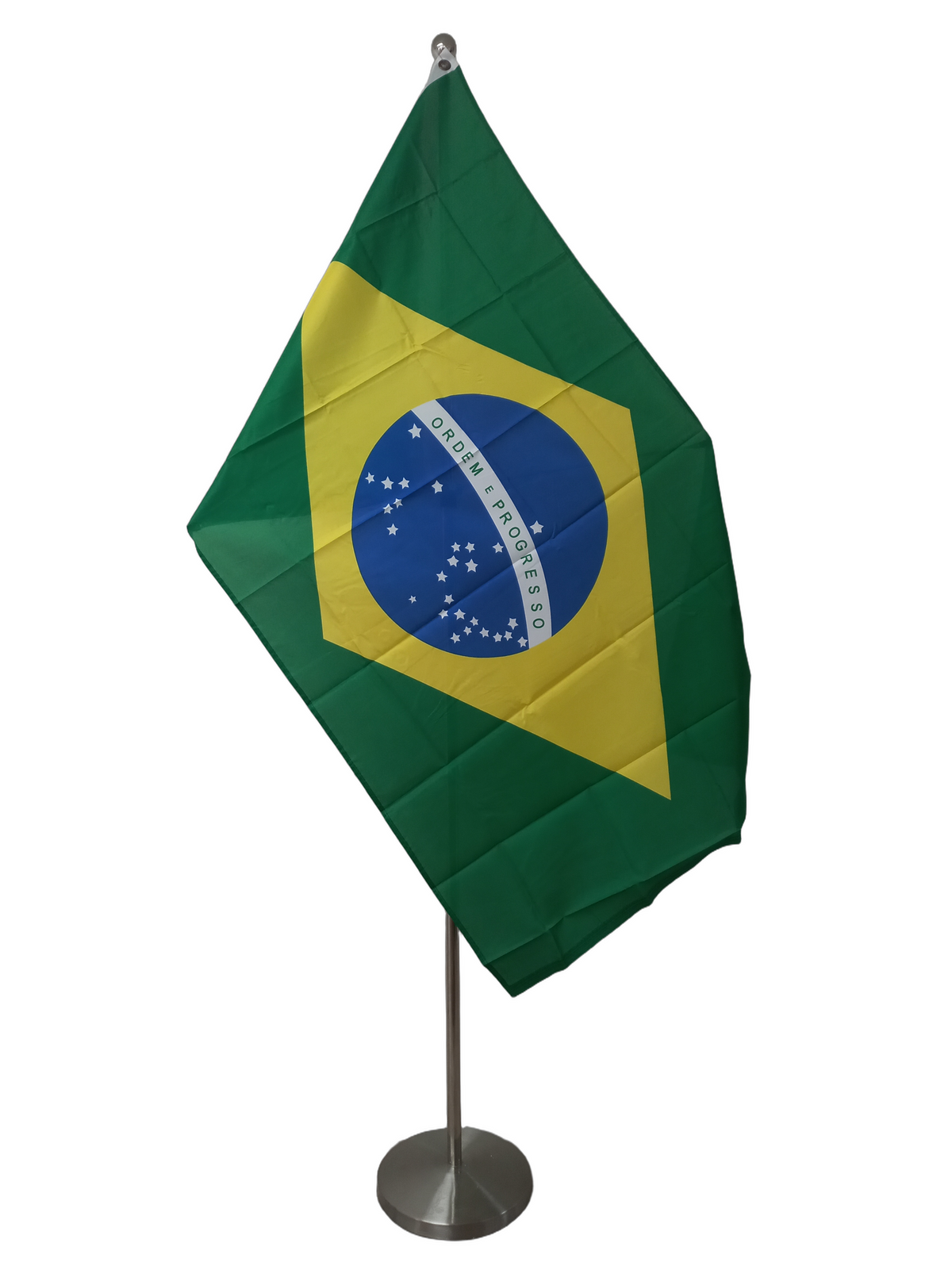 Flag of Brazil, green background with yellow diamond and a blue circle with star constellations and a white band with the text 'ORDEM E PROGRESSO'. On a ceremonial flag pole.