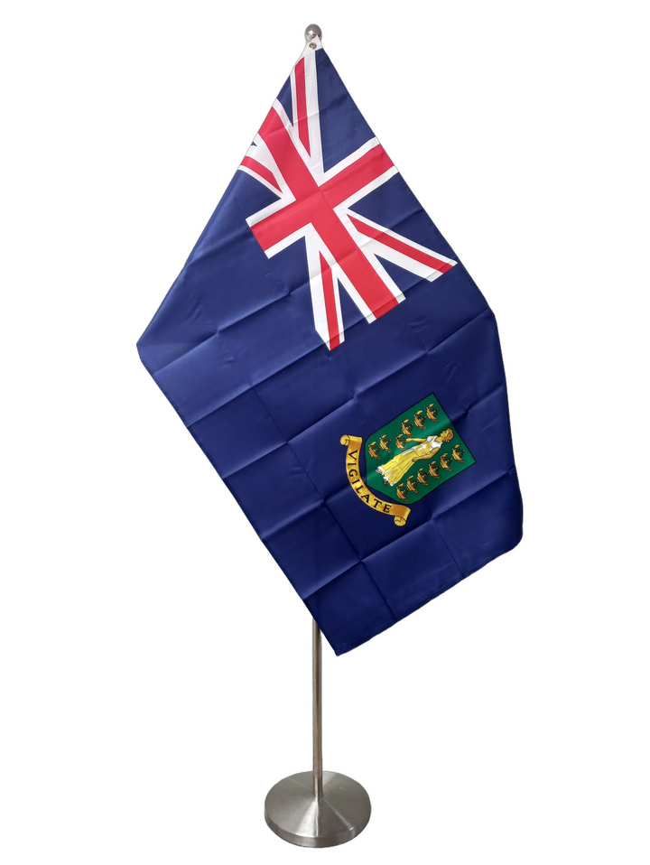 Flag of the British Virgin Islands, a blue background with the union jack in the upper left and a coat of arms featuring a female figure and lamps. On a ceremonial flag pole.