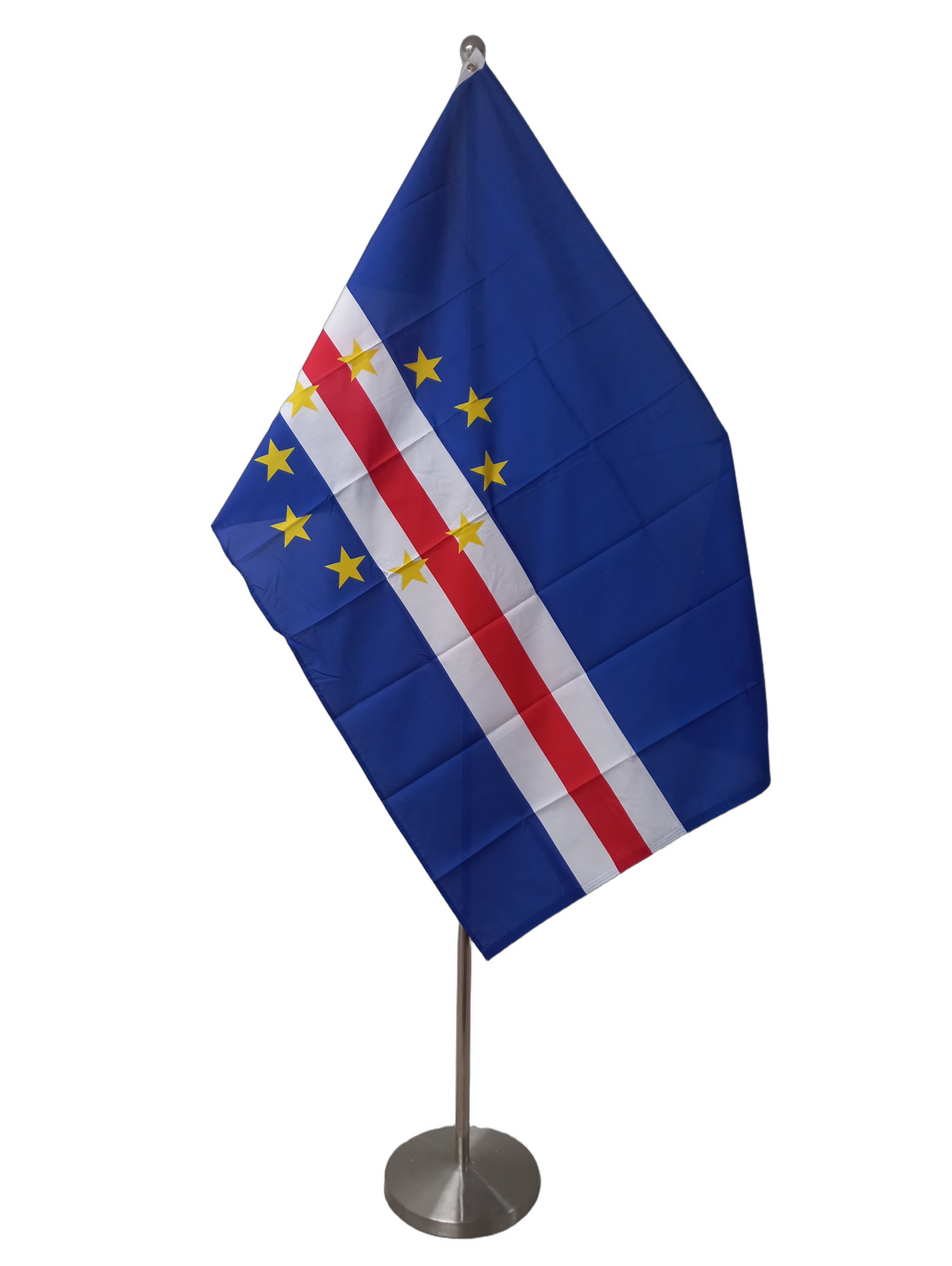 Flag of Cape Verde featuring a blue field with a red horizontal stripe and multiple gold stars, with two metal grommets for flying. On a ceremonial flag pole.
