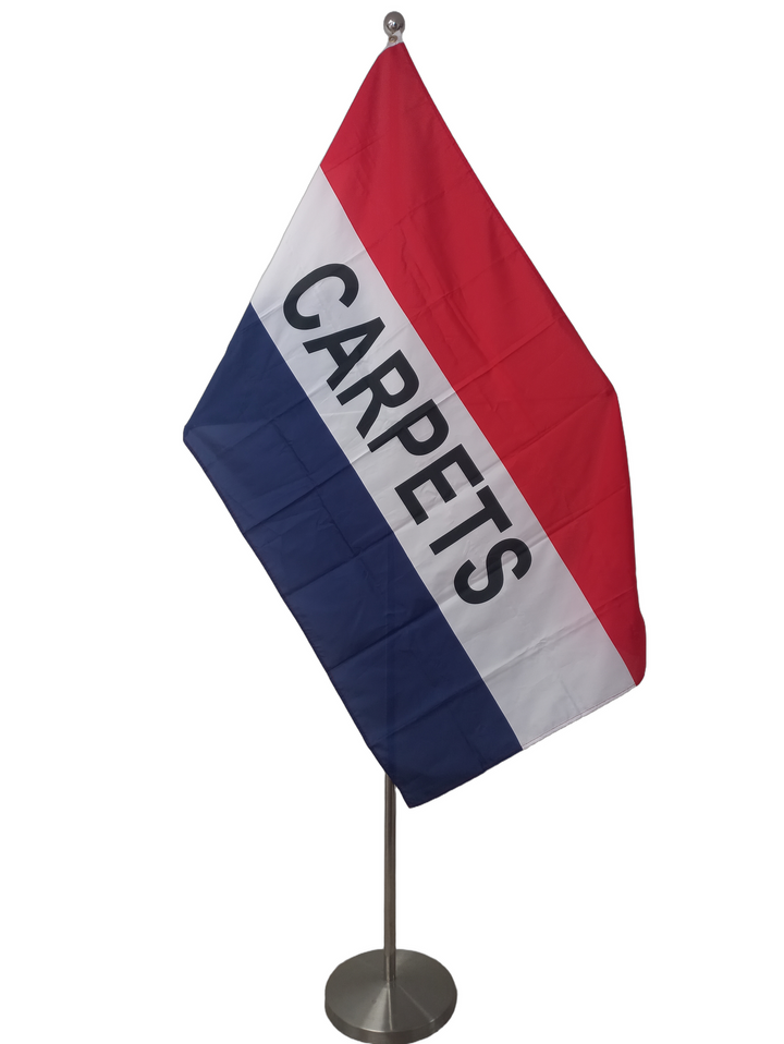 Red, white and blue horizontal stripes with 'CARPETS' on the white stripe. On a ceremonial flag pole.