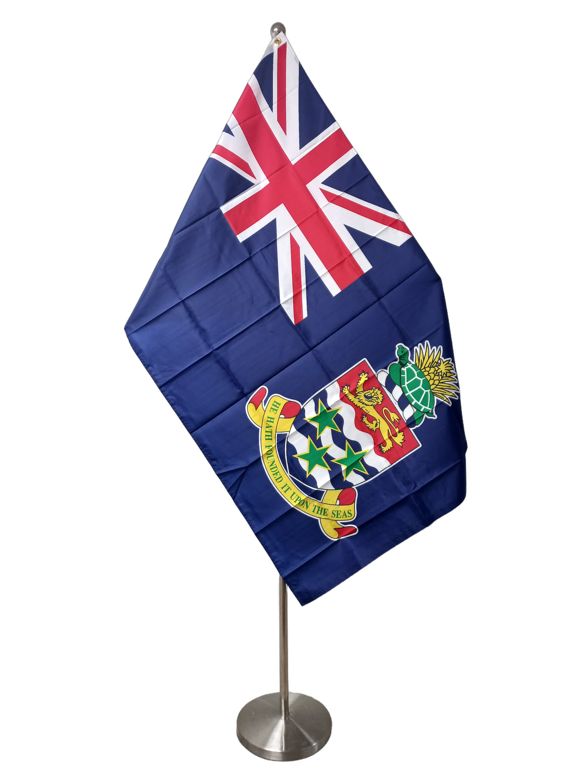 Flag of the Cayman Islands featuring a Union Jack canton with the Cayman Islands coat of arms on a blue field. The flag has two metal grommets for flying. On a ceremonial flag pole.