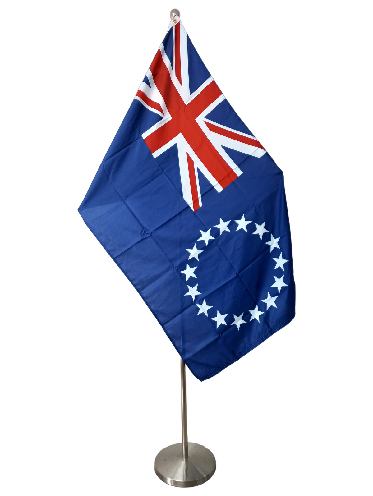 Flag of Cook Islands featuring a blue field with a unique star circle design, a red and white union jack, and two metal grommets for flying. On a ceremonial flag pole.