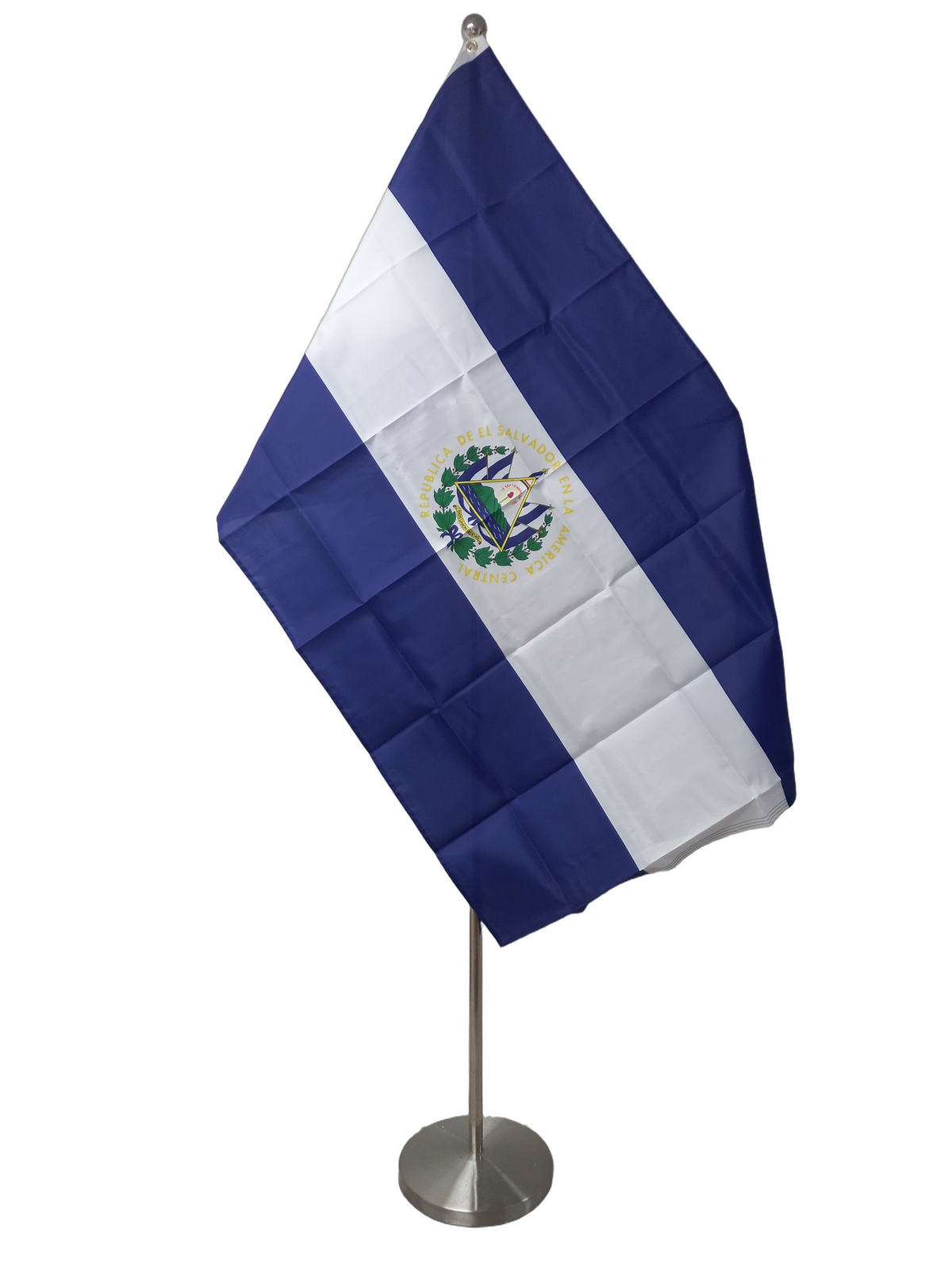 Flag of El Salvador with horizontal stripes of blue and white, featuring the national coat of arms in the center, and two metal grommets for flying. On a ceremonial flag pole.