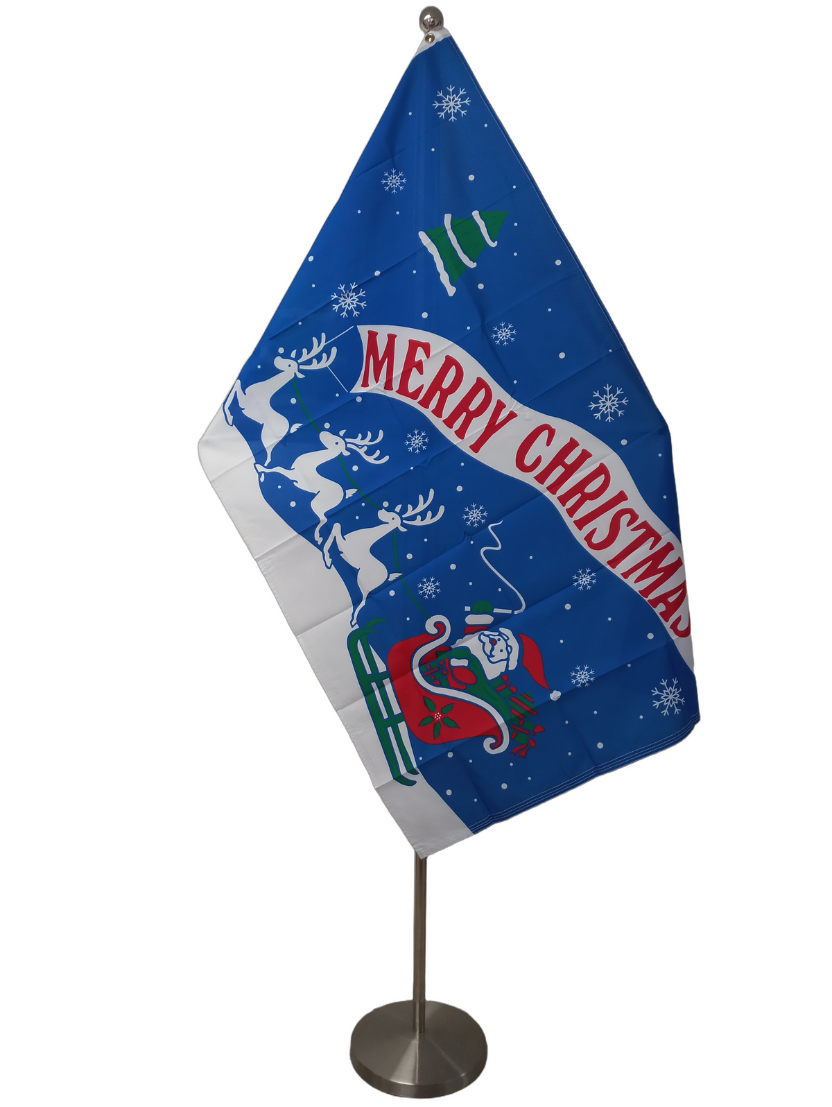 A Christmas-themed flag with a blue background featuring Santa Claus, reindeer, a Christmas tree, and the text 'Merry Christmas'. On a ceremonial flag pole.