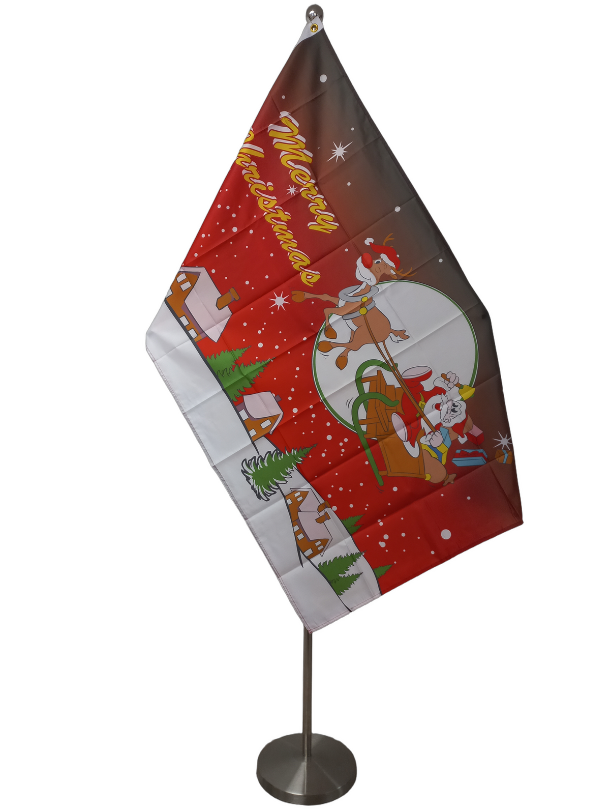 A Christmas flag featuring Santa Claus and a sleigh with reindeer, set against a red background with snow and houses. On a ceremonial flag pole.