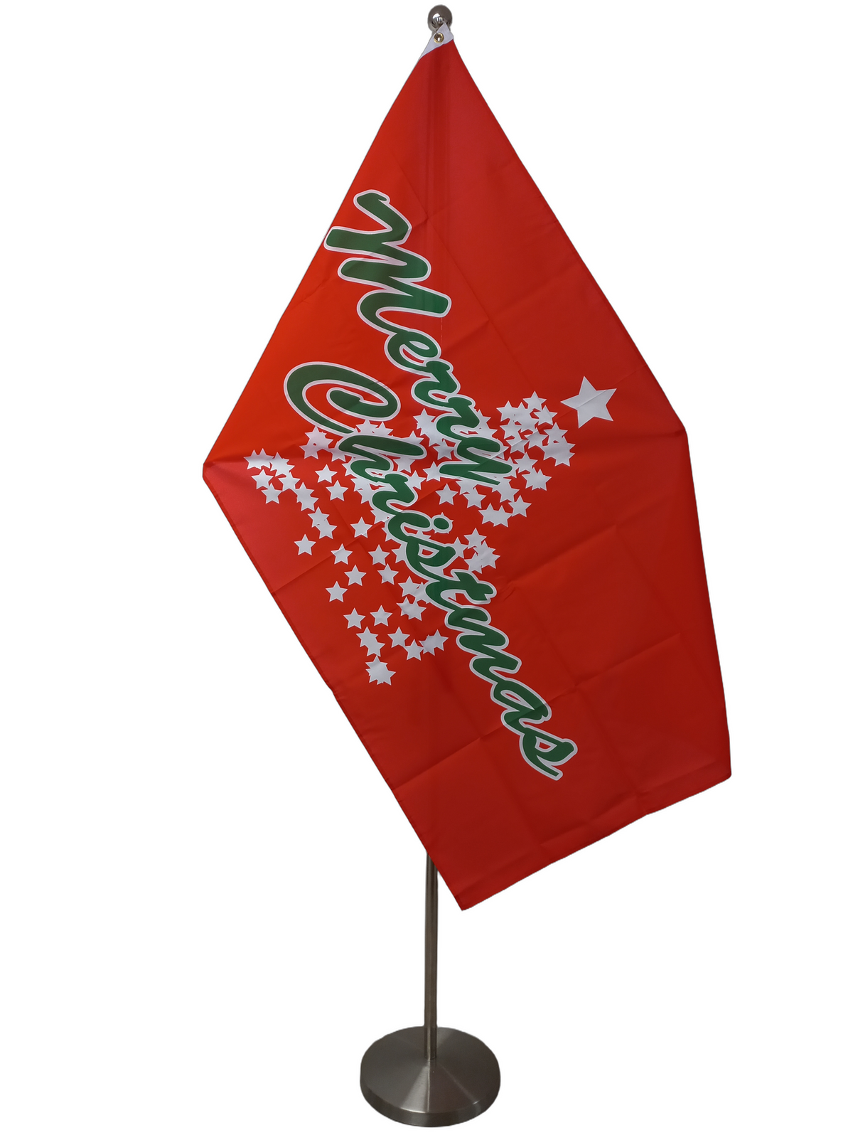 A flag with a red background and a tree formed by stars with the text 'Merry Christmas' written in green. On a ceremonial flag pole.