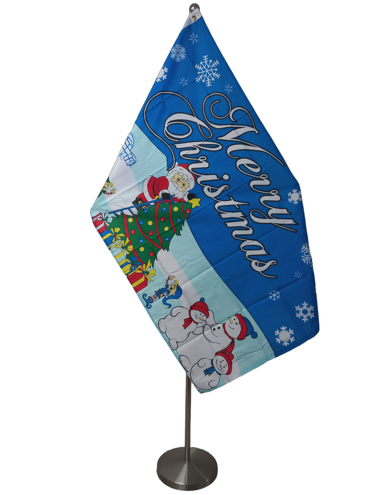 A Christmas-themed flag with the text 'Merry Christmas' displayed prominently. The flag shows an illustration of Santa Claus, a Christmas tree, snowflakes, and other festive imagery against a blue background. On a ceremonial flag pole.